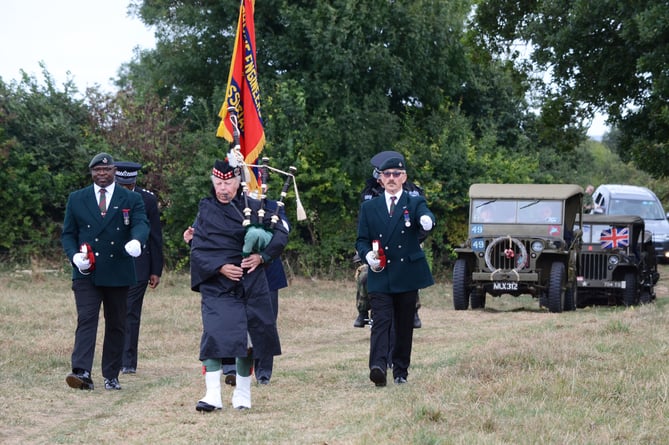  A Piper leads the procession of guests to the Memorial. 