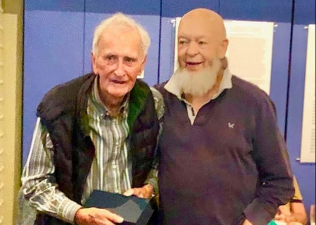 Francis Hillier, Chairman of the Somerset Miners’ Welfare Trust for  25 years receives an engraved glass plaque from former coal miner, Michael Eavis.