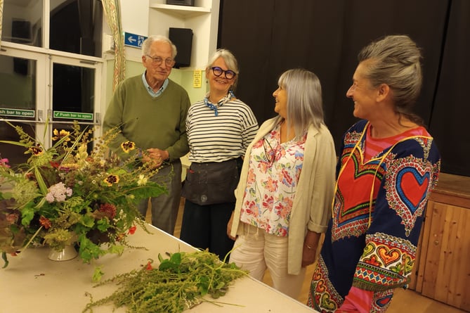 The speaker, Fiona Haser Bizony (second left) with members of Kilmersdon Gardeners and her flower arrangement. Left to right – Alan Brady, Fiona Haser Bizony (speaker), Angie Cook and Catherine Hughes.