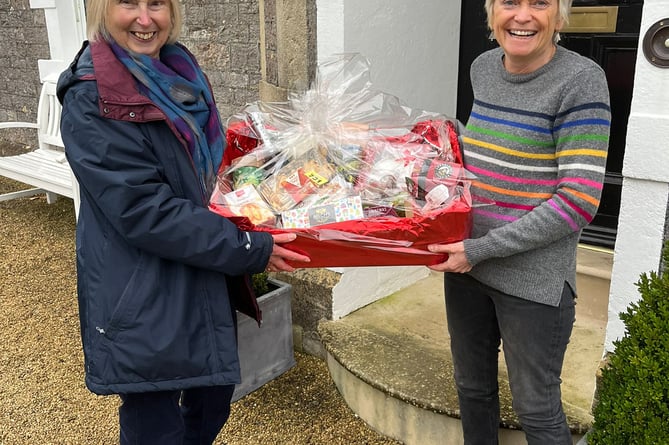 First prize for the raffle was won by Di Marshall with committee member Chris Scott on the right.