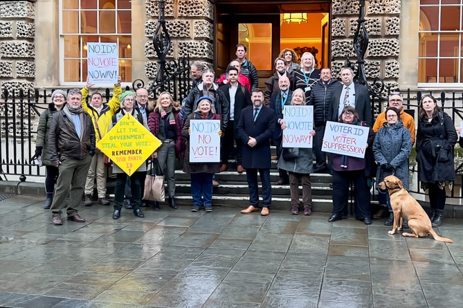 Council leader Kevin Guy (center) and other councillors with protestors outside the Guildhall on Thursday