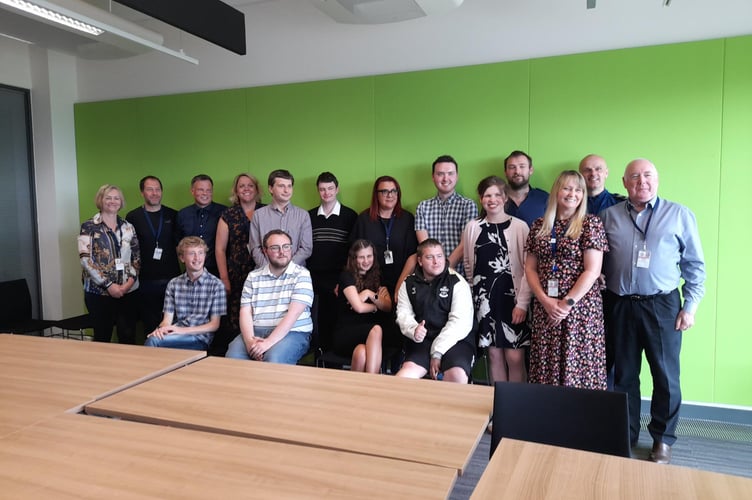 The interns with their work placement managers at their graduation ceremony. 