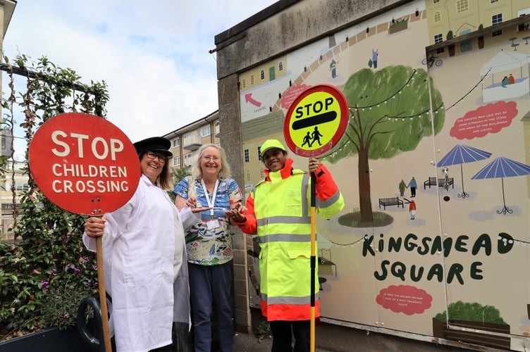 Cllr Manda Rigby presents two School Crossing Patrollers (one in modern uniform, one in historical uniform) with their platinum jubilee badges. 