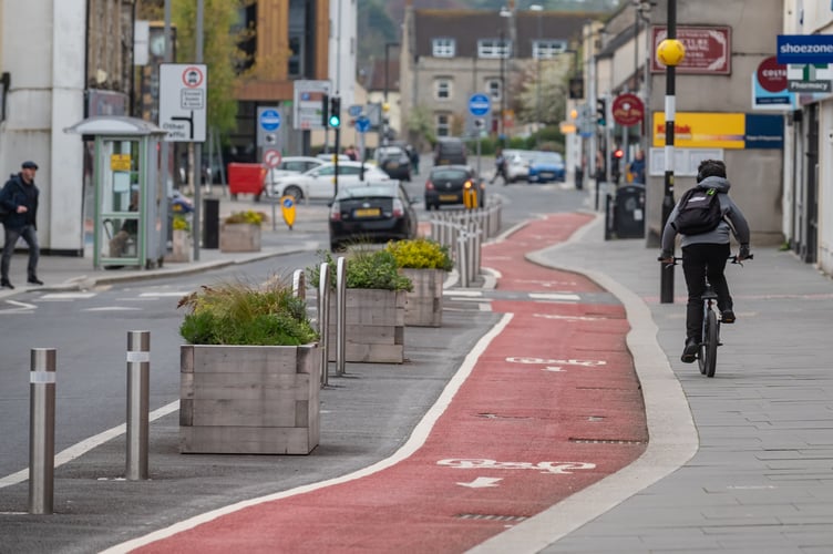 GV of the cycle lane on High Street, Keynsham. See SWNS story SWLNlane. An 'optical illusion' has injured nearly 60 cyclists on poorly-designed cycle lane. A recent freedom of information request showed that a staggering 59 people were injured on the lane on Keynsham High Street in Bristol. Photos of the lane, which installed last March shows how the lane appears to be flat at a glance - but actually passes over an elevated pedestrian crossing. Cyclists have repeatedly missed the 'bump' in the road, throwing them off their bikes as they hit it at speed - which one City Councillor is warning could lead to deaths.  