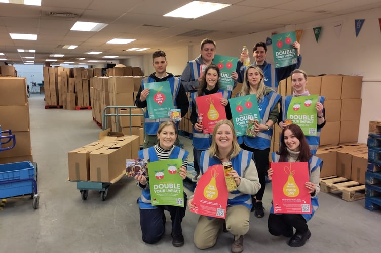 Photo: volunteers from Rathbone Greenbank in the emergency warehouse, after a day packing food parcels for families