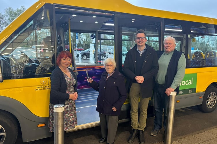 Marion Harrington (centre) cuts the ribbon to open the new 2V service, with councillors Liz Hardman (left), Grant Johnson (third from left), and Cyril Mitchard (right) 