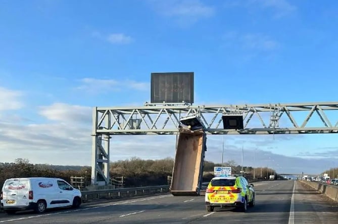 FILE PHOTO - The lorry trailer stuck on a gantry between junction 17 at Cribbs Causeway and junction 18 at Avonmouth. Photo released June 19 2024. A tipper truck driver who crashed into an overhead gantry leaving the vehicle vertical on a motorway has been convicted of dangerous driving. The incident in March 2023 led to the M5 being closed for about 14 hours due to concerns the gantry could collapse. Anthony Baker, 48, had denied the charge but was convicted by a jury after a two-day trial at Bristol Crown Court. Baker got behind the wheel of the 32-tonne lorry from a quarry in Flax Bourton and drove to a construction site at Cribbs Causeway. 