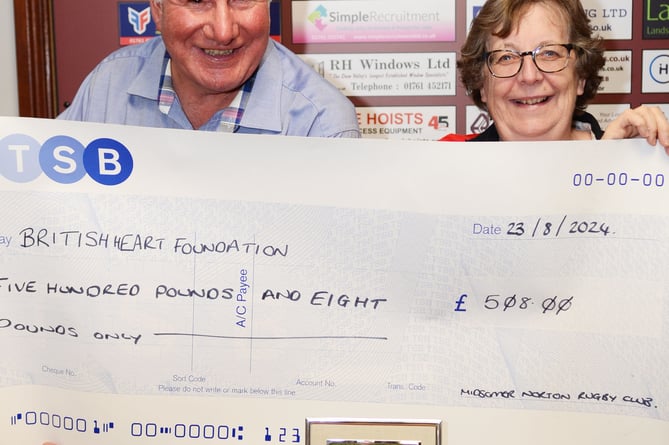 Pictured with Dave Stock the Quizmaster is Simon's widow Jenny Mollison and a cheque of £508 for the British Heart Foundation.