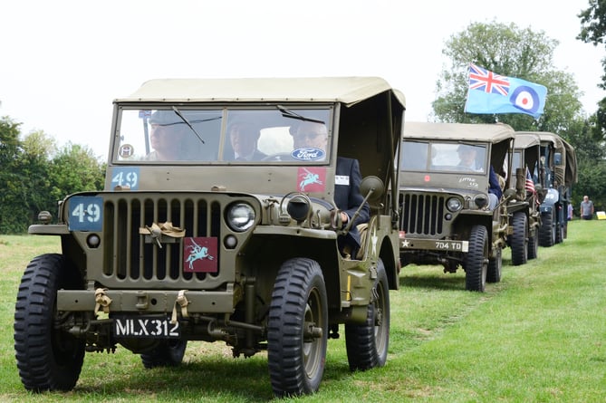 Dignitaries were driven to the service site by a convoy of vintage military vehicles