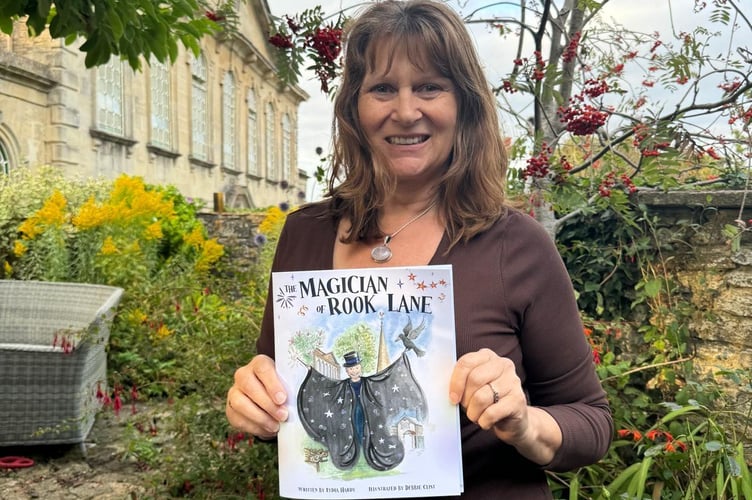 Lydia Hardy holding The Magician of Rook Lane, which aims to inspire young readers while supporting mental health charities.