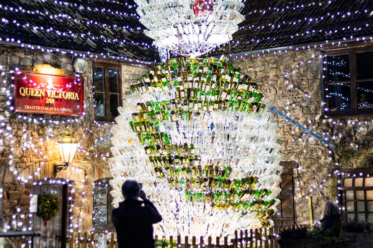 The UK's 'most festive pub' has become home to a 26-foot snowman made of 2,500 wine bottles lights this festive season. The Queen Victoria Inn in Priddy, Somerset, has been putting on Christmas lights displays for the past decade - as a way to raise funds for charity. This year the popular pub features a huge wreath on the side of the building, a Christmas tree and a snowman made from hundreds of empty wine bottles. Priddy, Somerset. Photo released December 17 2024. Britainâs 'most festive pub' has become home to a 26-foot snowman - made from 2,500 wine bottles. The Queen Victoria Inn in Priddy, Somerset, has been putting on Christmas lights displays for the past decade - as a way to raise funds for charity. This year the popular pub features a huge wreath on the side of the building, a Christmas tree and a snowman made from hundreds of empty wine bottles. The pub is also covered in 55,000 Christmas lights collected over the years and 15km of cabling.
