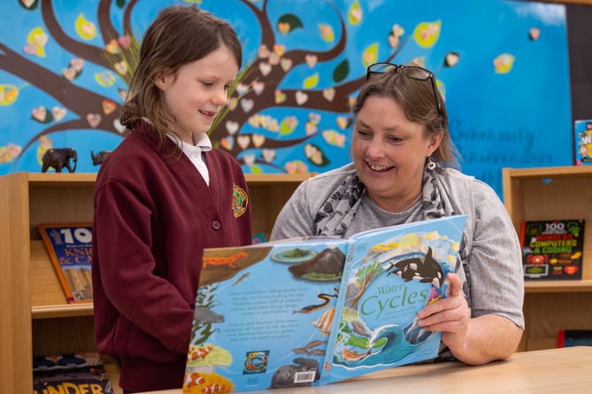 Headteacher of St Marys Cathie Lampert reading with Student.