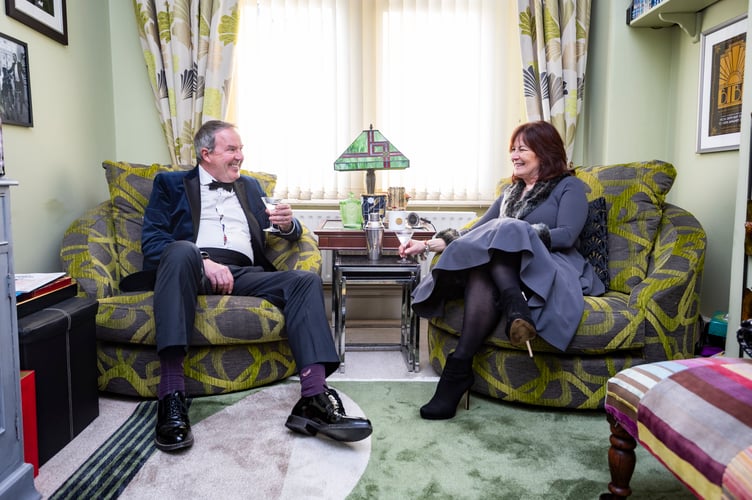 Ian and Yvette Perryman from Bristol who have turned their front room into an art deco picture house - covered in memorabilia and a gin bar with 80 different bottles. Photo released March 4 2025. Monday nights have been renamed Martini Mondays - when they sit down to watch a classic film from the black and white movie era with a glass of dry Martini.