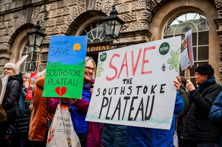 A placard reading 'Save the Plateau'